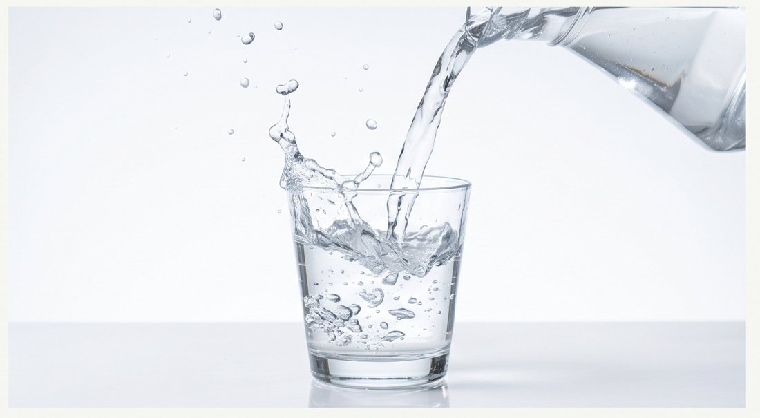 Clear water being poured into a drinking glass